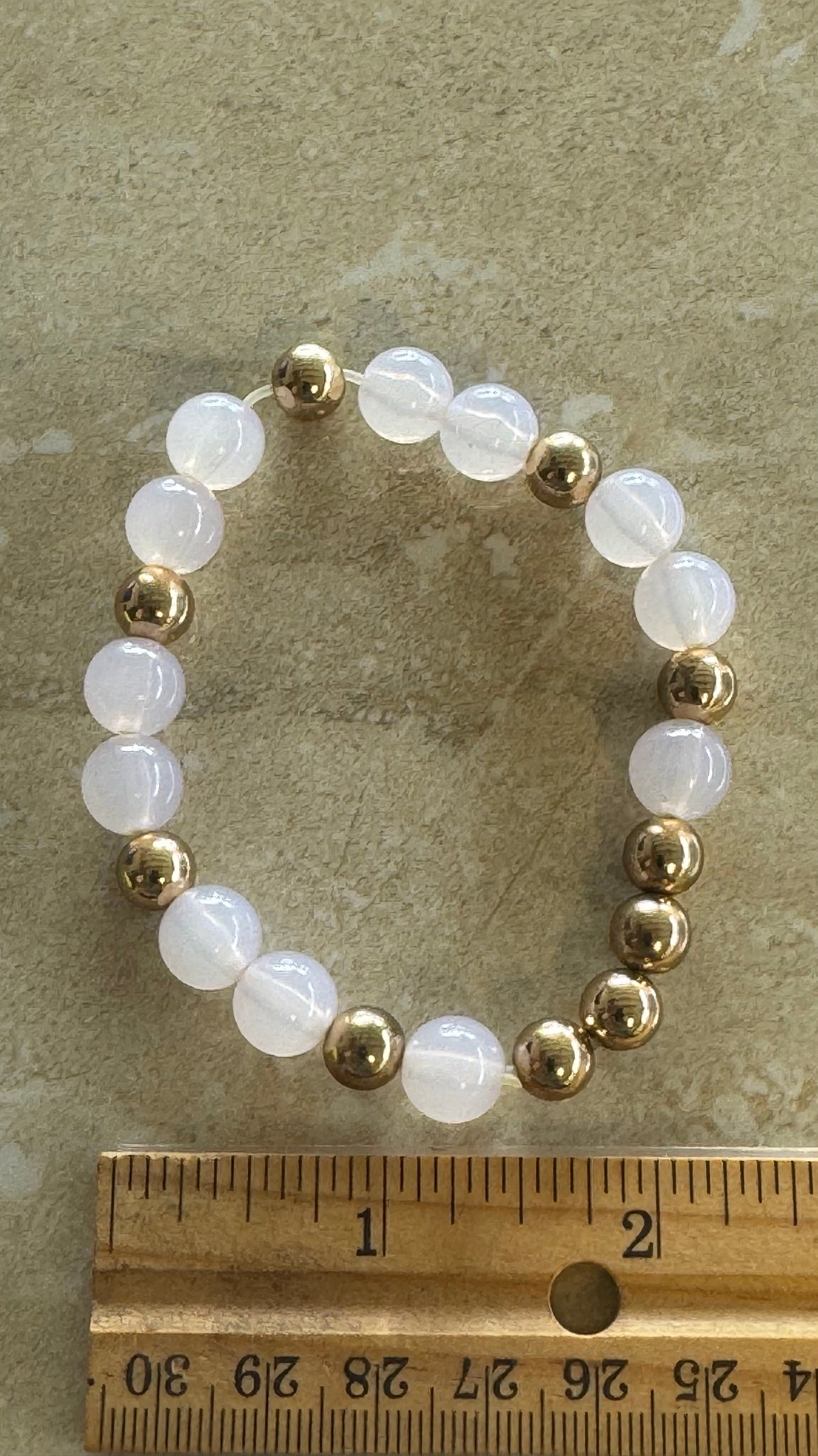 Multi beaded white a gold flex bracelet 2(1/3)” diameter