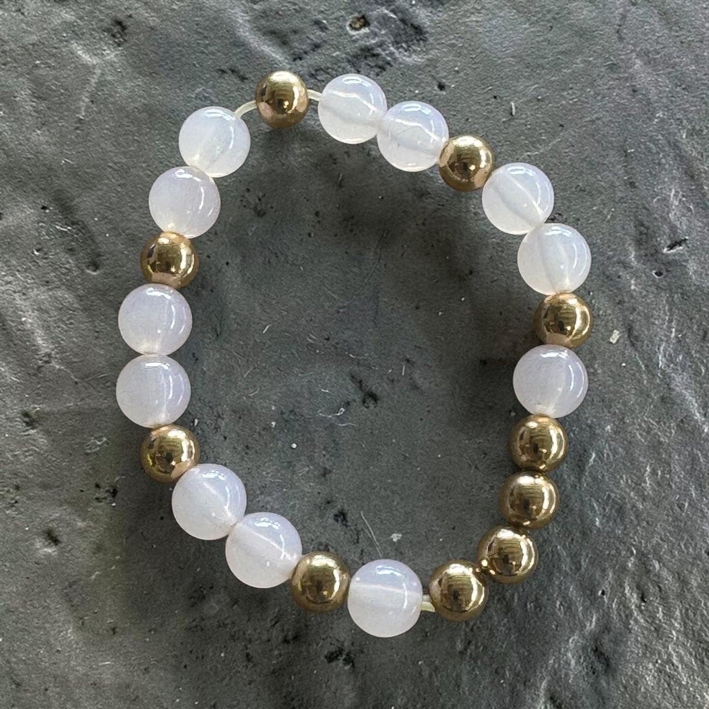 Multi beaded white a gold flex bracelet 2(1/3)” diameter