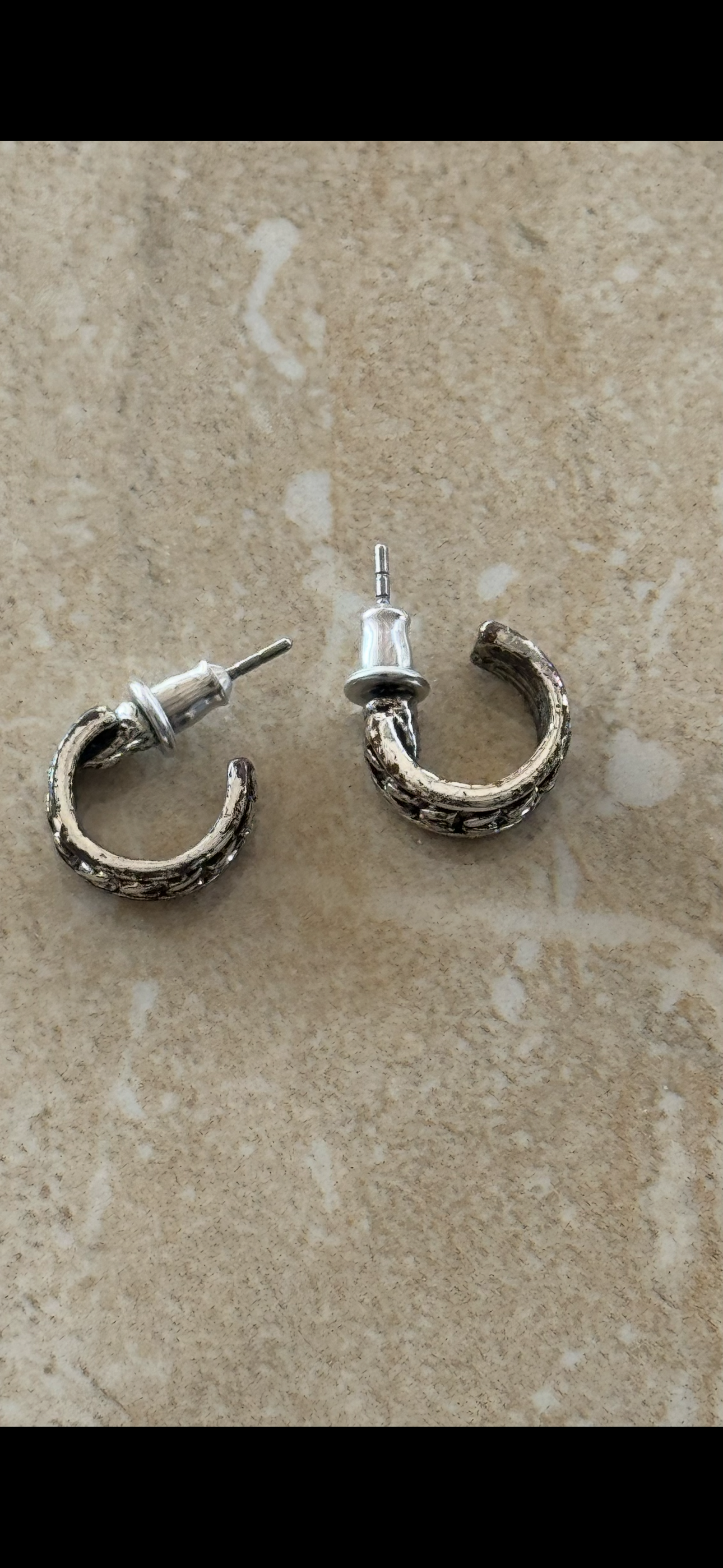 brutalist-style textured silver hoop earrings