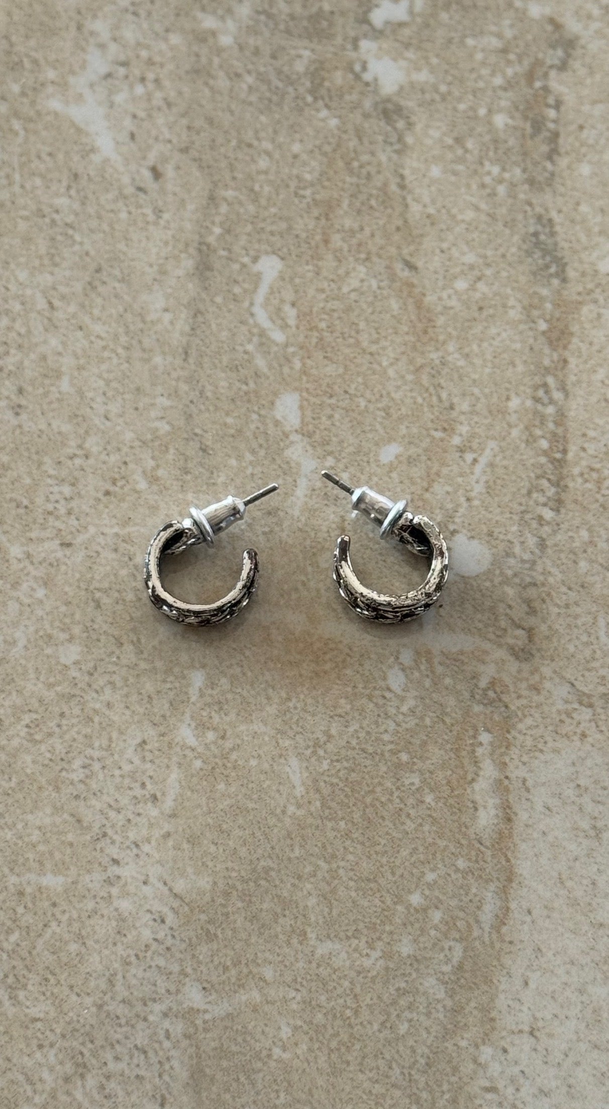 brutalist-style textured silver hoop earrings