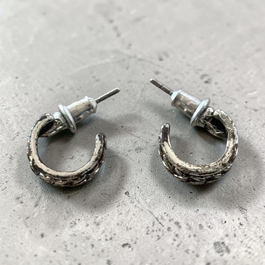 brutalist-style textured silver hoop earrings